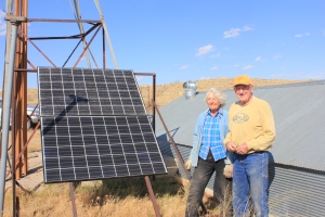 Jean & Bob Harshbarger stand beside one of the solar panels that is on the ranch