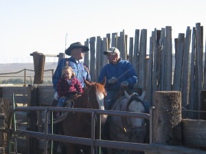 Jentry helping her great grandpa bring cattle up the alley.